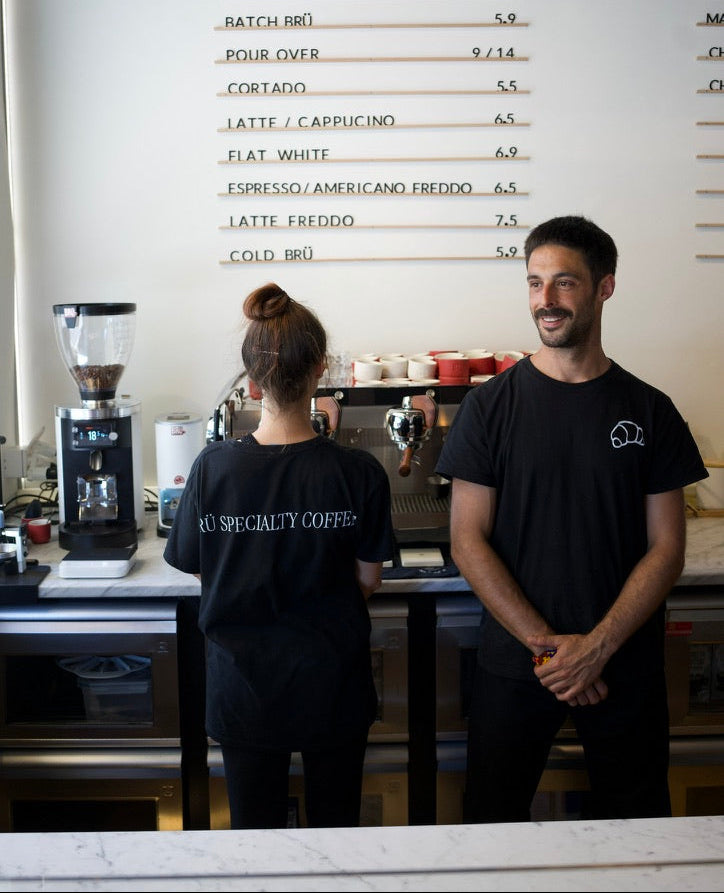 Brü Specialty Coffee branded t-shirt with croissant graphic — premium coffee culture tee